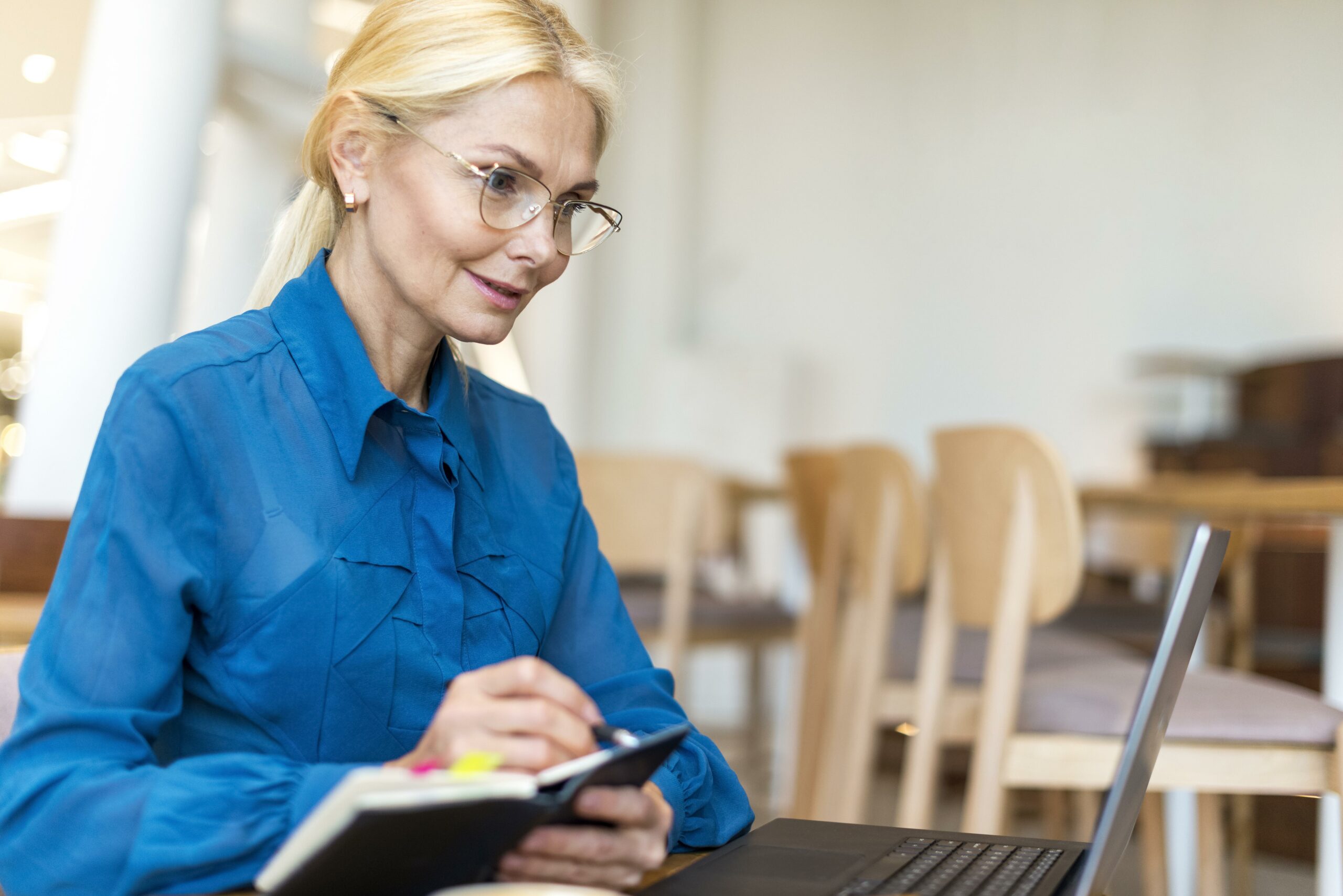 side-view-of-older-business-woman-with-glasses-working-on-laptop